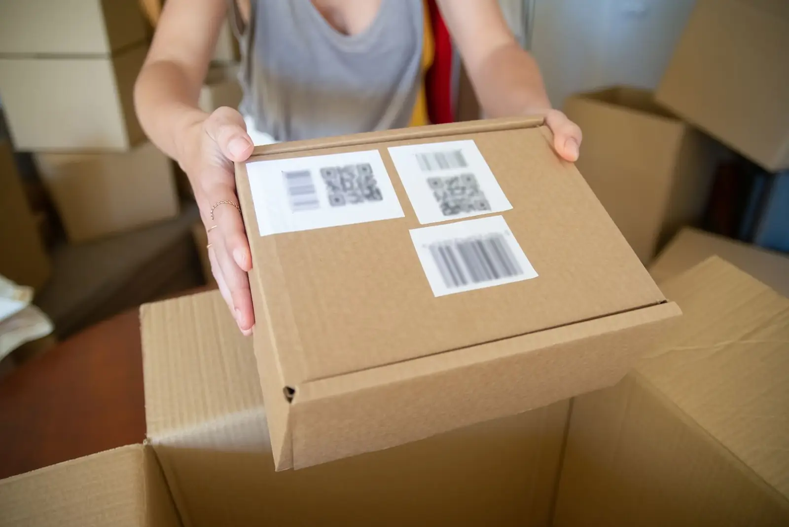 Hands holding a labeled shipping box